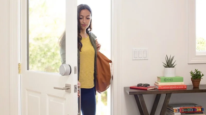 August Smart Lock Pro installed on a door that opens into a house